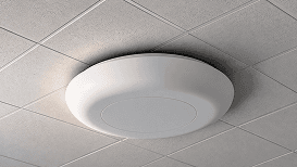White wireless access point mounted on a ceiling